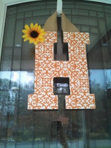 Orange Design Fabric Covered Letter. Letters are 13 1/2 inches tall with added decor piece and burlap hanger. Decor piece can be customized upon request!